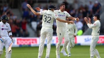 James Anderson of England celebrates with Craig Overton and Rory Burns taking the wicket of Virat Kohli of India at Emerald Headingley Stadium on August 25, 2021 in Leeds, England