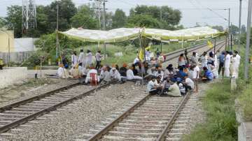 Farmers block railway tracks during their indefinite protest demanding higher sugarcane State Advisory Price (SAP), in Jalandhar.