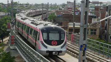 A metro train runs on a track after Delhi Metro's remaining portion of the Pink Line corridor.