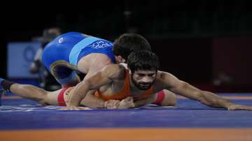 Ravi Dahiya and Russian Olympic Committee Zavur Uguev compete during the men's 53kg Freestyle wrestling final match at the 2020 Summer Olympics, Thursday, Aug. 5, 2021, in Tokyo, Japan. (AP Photo/Aaron Favila)