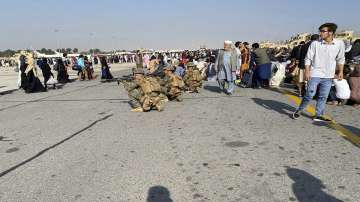 U.S soldiers take a position to guard along a perimeter at the international airport in Kabul