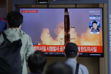 People watch a TV screen showing a news program reporting about North Korea's missiles with file image in Seoul, South Korea, Wednesday, Sept. 15, 2021. North Korea fired two ballistic missiles into waters off its eastern coast Wednesday afternoon, two days after claiming to have tested a newly developed missile in a resumption of its weapons displays after a six-month lull. The letters read "North Korea fired two ballistic missiles."