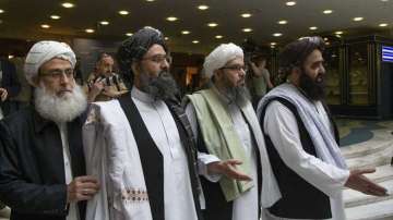 Mullah Abdul Ghani Baradar, the Taliban group's top political leader, second left, arrives with other members of the Taliban delegation for talks in Moscow, Russia.