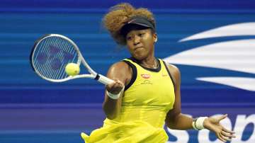 Naomi Osaka, of Japan, returns a shot to Marie Bouzkova, of the Czech Republic, during the first round of the US Open tennis championships, Monday, Aug. 30