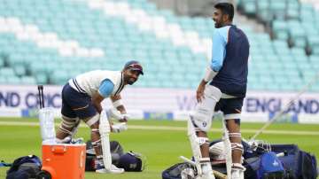 India's Ajinkya Rahane pads up with teammate Ravichandran Ashwin
