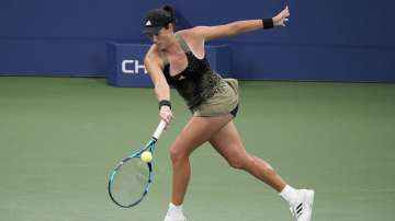 Garbine Muguruza, of Spain, returns a shot to Andrea Petkovic, of Germany, during the second round of the US Open tennis championships, Wednesday, Sept. 1