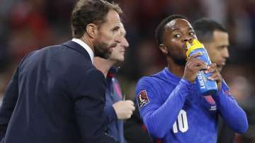 England's manager Gareth Southgate talks to Raheem Sterling during the World Cup 2022 group I qualifying soccer match between Hungary and England at the Ferenc Puskas stadium in Budapest, Hungary, Thursday, Sept. 2