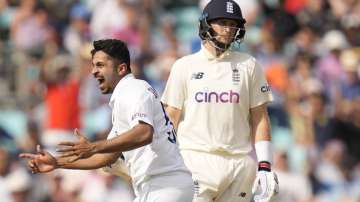 India's Shardul Thakur celebrates taking the wicket of England's Joe Root, right, on day five of the fourth Test match at The Oval cricket ground in London, Monday, Sept. 6