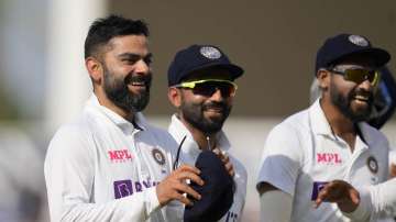 India's captain Virat Kohli smiles as he leaves the pitch for tea on day five of the fourth Test match at The Oval cricket ground in London, Monday, Sept. 6