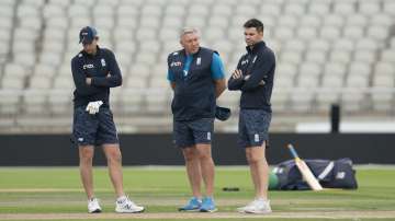 England's captain Joe Root, left, coach Chris Silverwood, center, and bowler James Anderson look at the pitch during a nets session before the 5th Test cricket match between England and India at Old Trafford cricket ground in Manchester, England, Thursday, Sept. 9