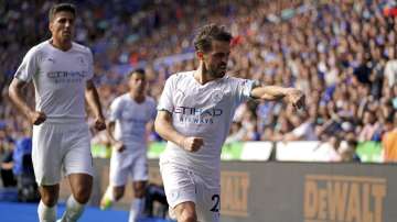 Manchester City's Bernardo Silva celebrates scoring their side's first goal of the game during their English Premier League soccer match at The King Power Stadium, Leicester, England, Saturday, Sept. 11