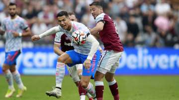 Manchester United's Cristiano Ronaldo, left, goes for the ball as West Ham's Pablo Fornals tries to stop him during the English Premier League soccer match between West Ham United and Manchester United at the London Stadium in London, England, Sunday, Sept. 19