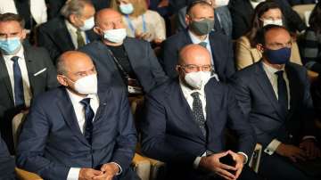 Slovenia's Prime Minister Janez Jansa, left, and European Council President Charles Michel, center, attend a meeting of the Bled Strategic Forum at the Bled Festival Hall in Bled, Slovenia.