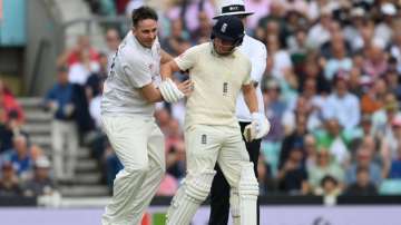 Pitch invader runs into Jonny Bairstow of England