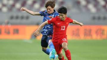 Jin Jingdao of China PR battles for possession with Kyogo Furuhashi of Japan during the 2022 FIFA Wo