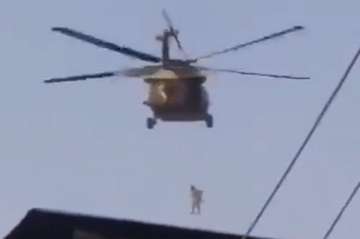 man seen hanging from US helicopter