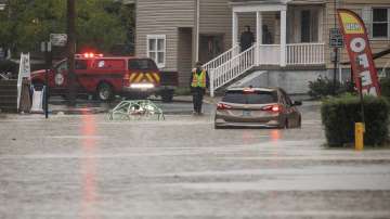 A car is stranded on a flooded street Wednesday, Sept. 1, 2021, in Bridgeville