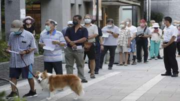 Members of Nationalist Party, or KMT, line up to cast their ballot for election of their party chairman at a polling station in Taipei, Taiwan, Saturday