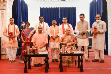 Uttar Pradesh Governor Anandiben Patel and Chief Minister Yogi Adityanath with newly sworn-in state ministers, during expansion of the Cabinet ahead of UP Assembly elections, in Lucknow, Sunday.