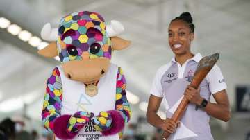 File photo of England netball international Layla Guscoth, right, holding the Commonwealth Games bat