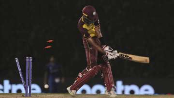 West Indies' Roston Chase is bowled out by Afghanistan's Hamid Hassan on a no-ball during the Cricke