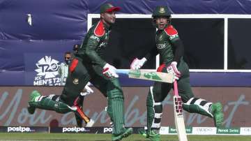 Bangladesh's Shakib Al Hasan and teammate Mushfiqur Rahim cross as they run between the wickets duri