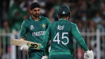 Pakistan's Shoaib Malik, left, celebrates with Asif Ali after hitting a boundary during the Cricket Twenty20 World Cup match between New Zealand and Pakistan in Sharjah, UAE, Tuesday, Oct. 26, 2021. 