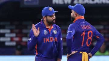 India's Rohit Sharma talks to captain Virat Kohli after the fall of Zealand's Martin Guptill wicket during the Cricket Twenty20 World Cup match between New Zealand and India in Dubai, UAE, Sunday, Oct. 31, 2021. 