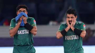 Babar Azam (L) and opener Mohammad Rizwan react after Pakistan defeated India in the ICC Men's T20 W