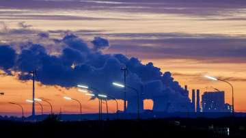 Steam comes out of the chimneys of the coal-fired power station Neurath near the Garzweiler open-cast coal mine in Luetzerath, Germany.