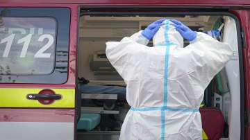 A paramedic adjusts his protection equipment outside the University Emergency Hospital in Bucharest, Romania