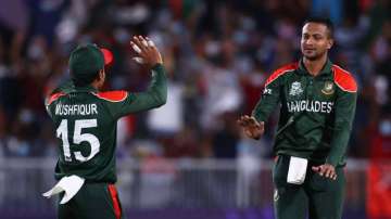 Bangladesh all-rounder Shakib Al Hasan (right) celebrates after taking a Scotland wicket with teamma