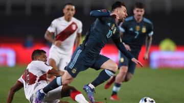  Lionel Messi of Argentina and Alex Varela of Peru fight for the ball during a match between Argenti