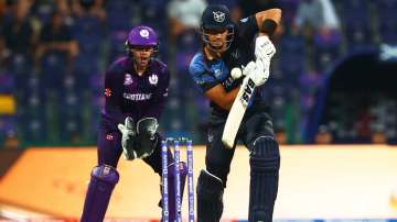  JJ Smit of Namibia plays a shot as Matthew Cross of Scotland looks on during the ICC Men's T20 Worl