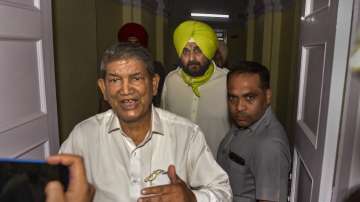 Punjab Pradesh Congress Committee chief Navjot Singh Sidhu with Congress' Punjab in-charge Harish Rawat after a meeting in New Delhi.