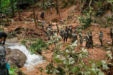 Rapid Action Force (RAF) and Kerala Fire and Rescue personnel during rescue operations at the site of landslide at Kavali in Kottayam district