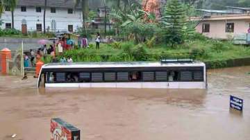 Kottayam: A bus partially submerged in a waterlogged area following heavy rains at Poonjaar in Kottayam on Saturday