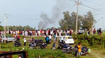 A vehicle set ablaze after violence broke out after farmers agitating were allegedly run over by a vehicle in the convoy of a union minister, in Lakhimpur Kheri.