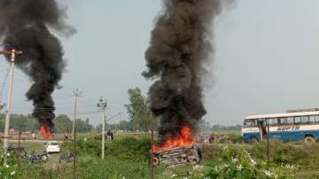 A vehicle was set ablaze after violence broke out after farmers agitating were allegedly run over by a vehicle in Lakhimpur Kheri