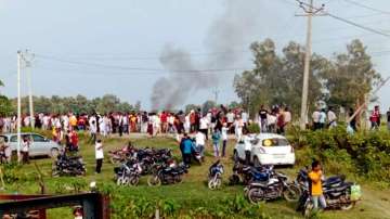 A vehicle set ablaze after violence broke out after farmers agitating were allegedly run over by a vehicle in the convoy in Lakhimpur Kheri