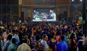 Cricket fans watch the World Cup T20 match of India and Pakistan, on a big screen, in Kolkata