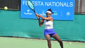 Sharmada Balu hits a backhand during Fenesta Open Nationals at the DLTA on Wednesday.