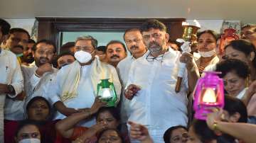 Bengaluru: KPCC President D K Shivakumar with former Karnataka chief minister Siddaramaiah and party leaders, holds a torch during a protest against the Lakhimpur Kheri incident, in Bengaluru