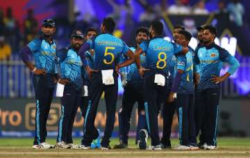 Sri Lankan players regroup after taking a wicket of the Netherlands in Sharjah on Friday.