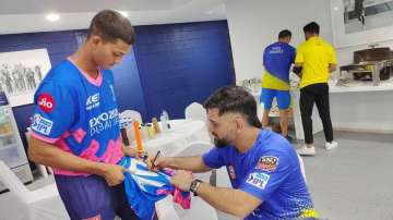 Yashasvi Jaiswal shows his bat with MS Dhoni's autograph on it below in Abu Dhabi on Saturday night.