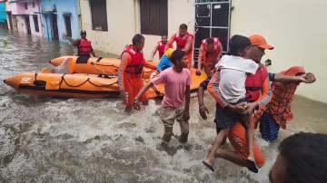 NDRF personnel rescue people stranded in floodwaters in Uttarakhand's Udham Singh Nagar.