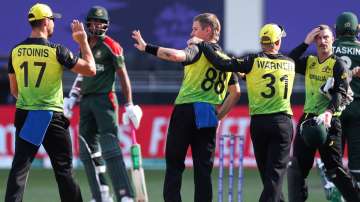 Australia's Adam Zampa, centre, is congratulated by teammates after taking the wicket of Bangladesh