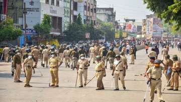 Policemen use tear gas to disperse protesters after Amravati Bandh turns violent, in Amravati.