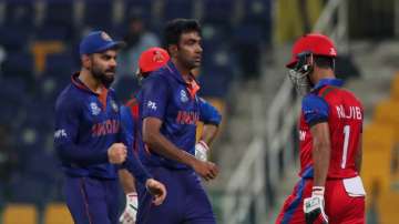 India's Ravichandran Ashwin, without cap, celebrates with captain Virat Kohli after dismissing Afgha