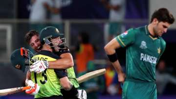 xPakistan's Shaheen Afridi, right, reacts as Australia's Matthew Wade, left, and Marcus Stoinis cele